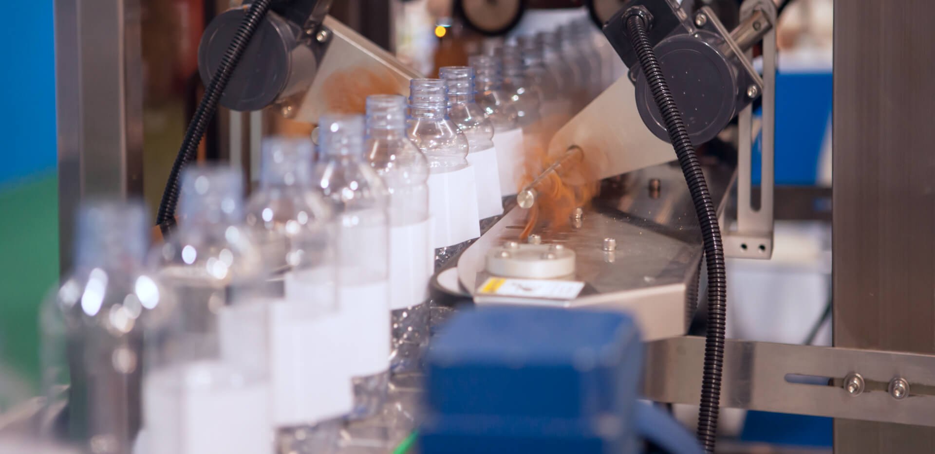 A machine is packaging bottles in a factory.